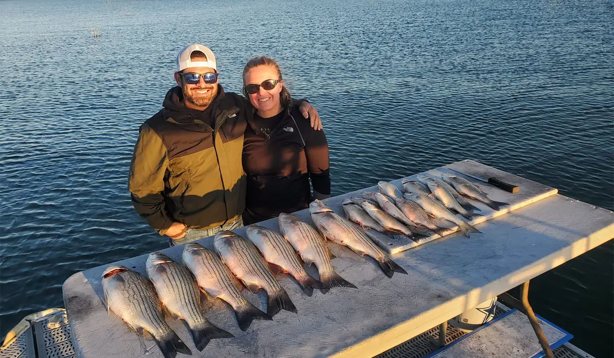 a couple with caught fishes at lake Buchanan