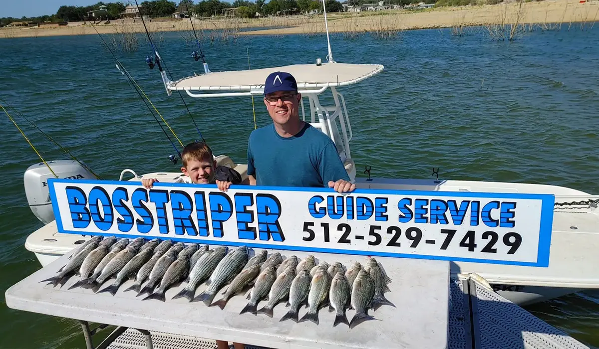 a man and a child with fishing guide service signage